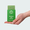 Hand holding a bar of Rosemary Mint Natural Essential Oil Soap Bar